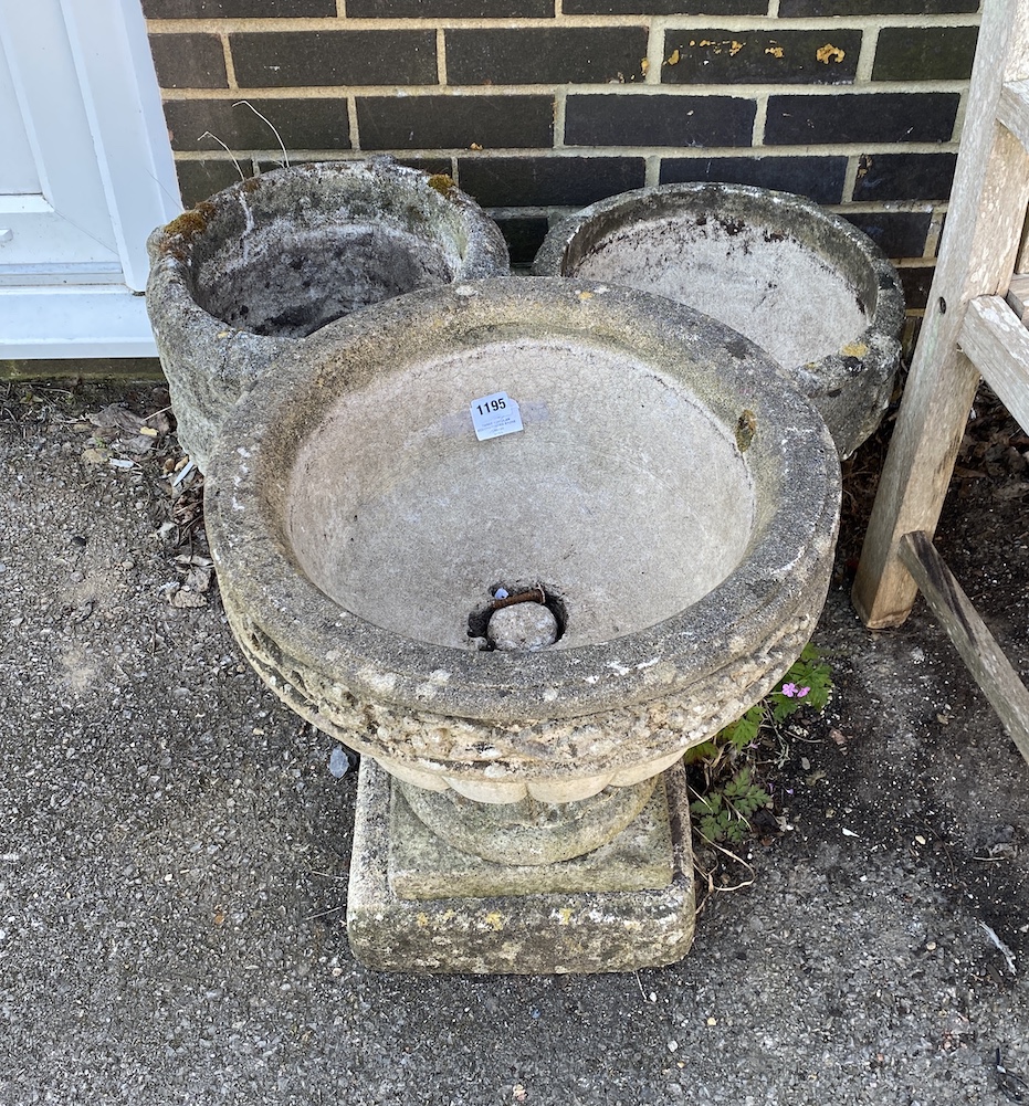 Three circular reconstituted stone garden planters, largest diameter 46cm, height 49cm *Please note the sale commences at 9am.